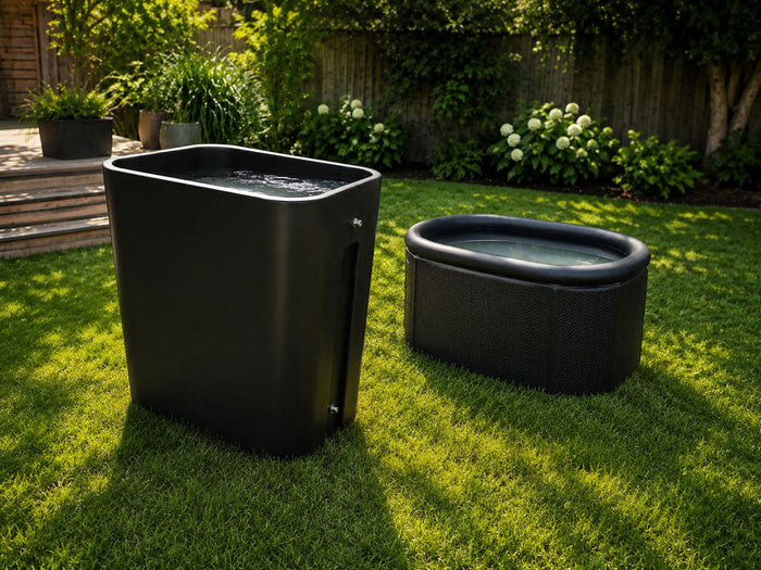 Hard-shell vertical cold plunge next to a portable inflatable ice bath on a backyard lawn, showing the difference in size and build.