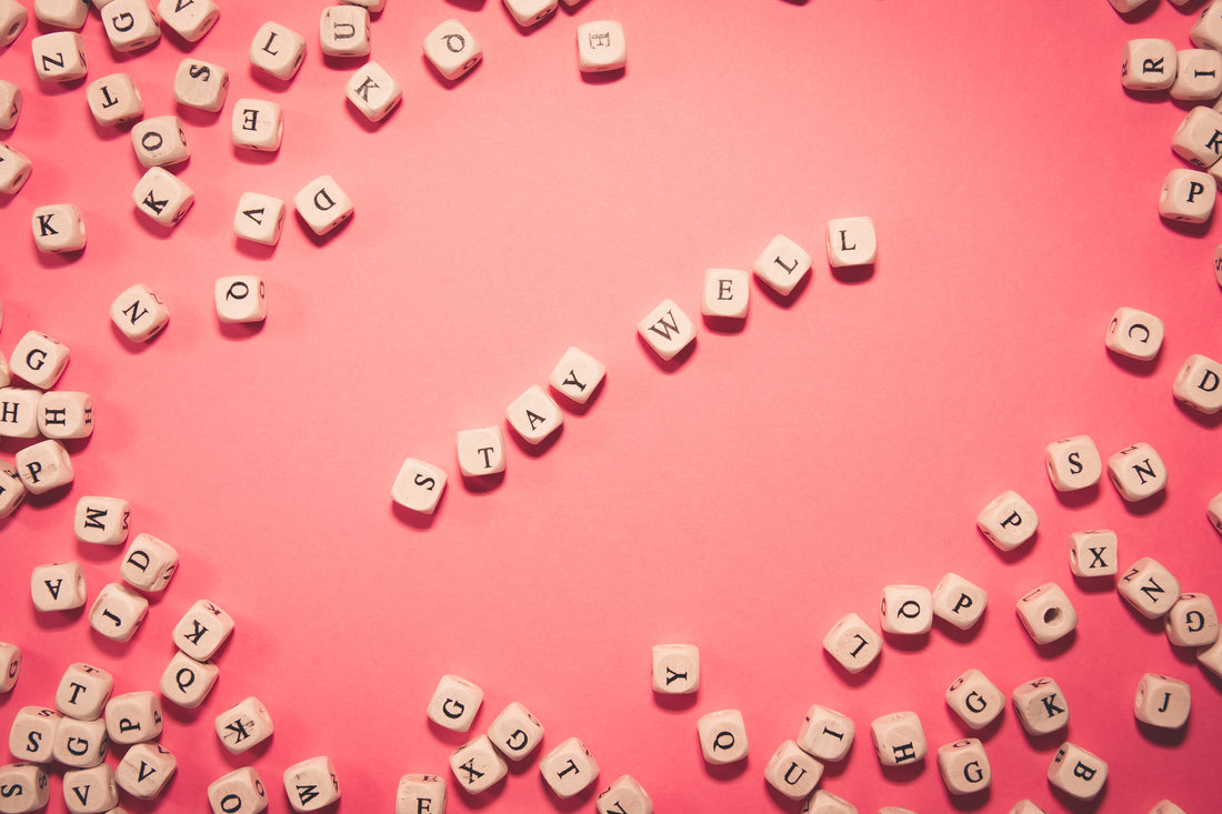 Flatlay image of colorful blocks arranged in the middle, spelling out "Stay Well" about Cold Therapy