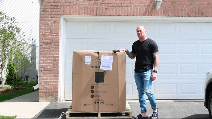 Jay standing next to his new Eternal Ice Bath HD Ultimate cold plunge on a backyard deck during the unboxing