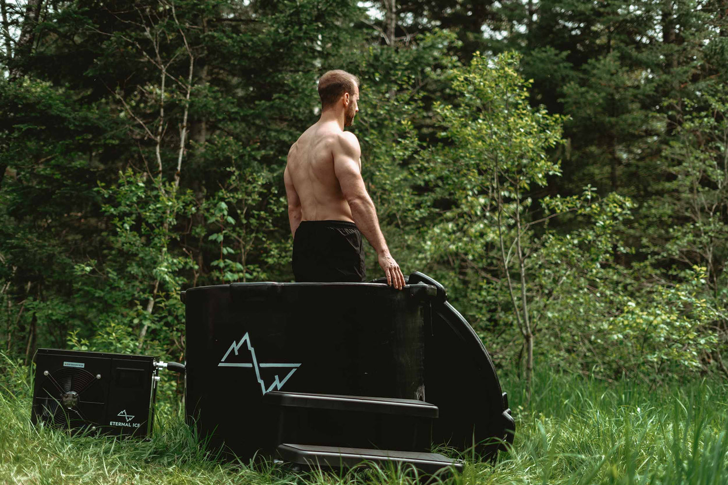 A man stands in his HD Pro bath, contemplating the surrounding scenery.